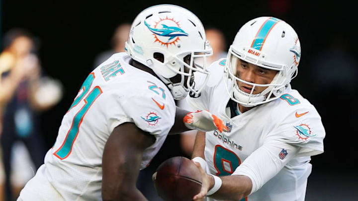 MIAMI, FL - OCTOBER 14: Brock Osweiler #8 of the Miami Dolphins hands off to Frank Gore #21 in the fourth quarter against the Chicago Bears at Hard Rock Stadium on October 14, 2018 in Miami, Florida. (Photo by Marc Serota/Getty Images)