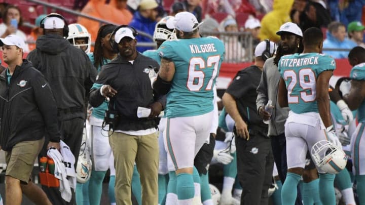 TAMPA, FLORIDA - AUGUST 16: Head coach Brian Flores of the Miami Dolphins talks with Daniel Kilgore #67 ahead of a preseason football game against the Tampa Bay Buccaneers at Raymond James Stadium on August 16, 2019 in Tampa, Florida. (Photo by Julio Aguilar/Getty Images)