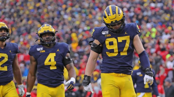 ANN ARBOR, MI – NOVEMBER 30: Aidan Hutchinson #97, Nico Collins #4 and Shea Patterson #2 of the Michigan Wolverines walk to the sidelines during the fourth quarter of the game against the Ohio State Buckeyes at Michigan Stadium on November 30, 2019 in Ann Arbor, Michigan. Ohio State defeated Michigan 56-27. (Photo by Leon Halip/Getty Images)