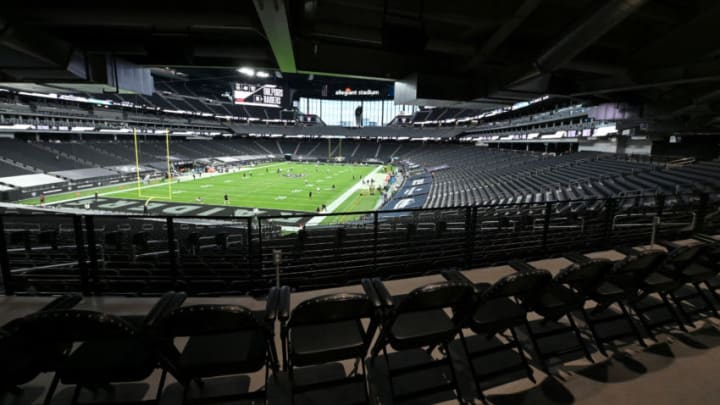 LAS VEGAS, NEVADA - DECEMBER 26: Empty seats are shown as players warm up before a game between the Miami Dolphins and the Las Vegas Raiders at Allegiant Stadium on December 26, 2020 in Las Vegas, Nevada. NFL games at the stadium are being played without fans in attendance because of the coronavirus (COVID-19) pandemic. (Photo by Ethan Miller/Getty Images)