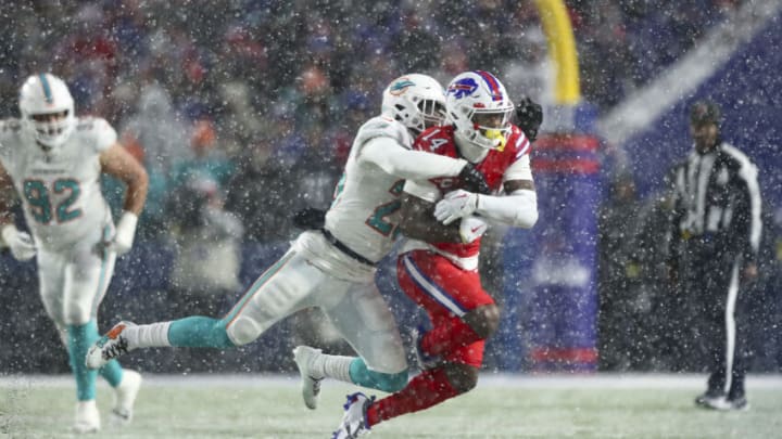 ORCHARD PARK, NY - DECEMBER 17: Xavien Howard #25 of the Miami Dolphins tackles Stefon Diggs #14 of the Buffalo Bills during the fourth quarter of an NFL football game at Highmark Stadium on December 17, 2022 in Orchard Park, New York. (Photo by Kevin Sabitus/Getty Images)