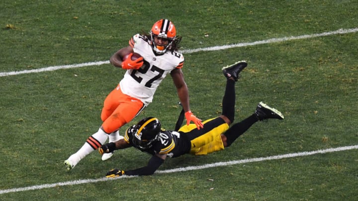 PITTSBURGH, PENNSYLVANIA - JANUARY 10: Kareem Hunt #27 of the Cleveland Browns avoids a tackle by Cameron Sutton #20 of the Pittsburgh Steelers during the second half of the AFC Wild Card Playoff game at Heinz Field on January 10, 2021 in Pittsburgh, Pennsylvania. (Photo by Joe Sargent/Getty Images)