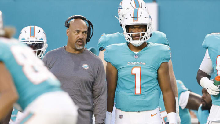 MIAMI GARDENS, FLORIDA - AUGUST 21: Co-offensive coordinator Eric Studesville and Tua Tagovailoa #1 of the Miami Dolphins look on during a preseason game against the Atlanta Falcons at Hard Rock Stadium on August 21, 2021 in Miami Gardens, Florida. (Photo by Michael Reaves/Getty Images)