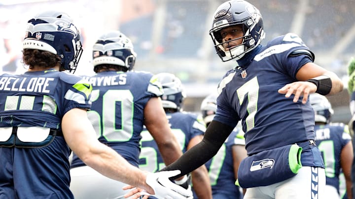 SEATTLE, WASHINGTON – DECEMBER 11: Geno Smith #7 of the Seattle Seahawks hi-fives Nick Bellore #44 of the Seattle Seahawks as the team runs onto the field prior to the game against the Carolina Panthers at Lumen Field on December 11, 2022, in Seattle, Washington. (Photo by Steph Chambers/Getty Images)