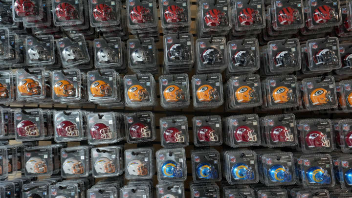 Oct 1, 2022; London, United Kingdom; Pocket mini helmets of the Cincinnati Bengals, Dallas Cowboys, Green Bay Packers, Kansas City Chiefs, Los Angeles Chargers, Los Angeles Rams, Miami Dolphins and Minnesota Vikings at the Tottenham Experience store at Tottenham Hotspur Stadium. Mandatory Credit: Kirby Lee-USA TODAY Sports