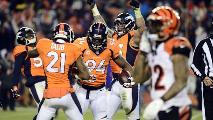 Dec 28, 2015; Denver, CO, USA; Denver Broncos outside linebacker DeMarcus Ware (94) and cornerback Aqib Talib (21) react to the overtime win against the Cincinnati Bengals at Sports Authority Field at Mile High. The Broncos defeated the Cincinnati Bengals 20-17 in overtime. Mandatory Credit: Ron Chenoy-USA TODAY Sports