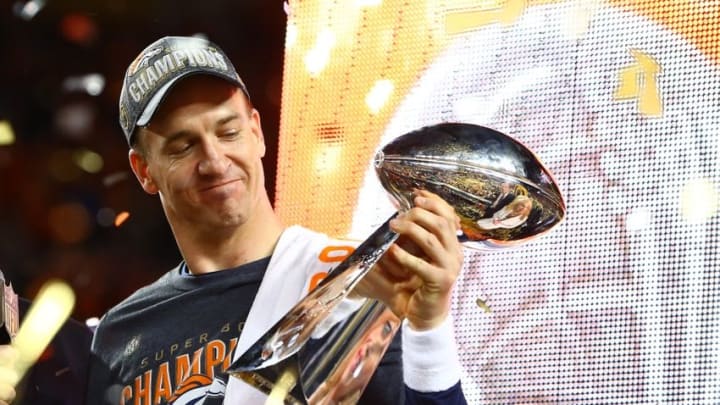 Feb 7, 2016; Santa Clara, CA, USA; Denver Broncos quarterback Peyton Manning (18) hoists the Vince Lombardi Trophy as he celebrates after defeating the Carolina Panthers in Super Bowl 50 at Levi