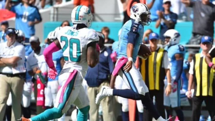 Oct 9, 2016; Miami Gardens, FL, USA; Tennessee Titans quarterback Marcus Mariota (8) runs the ball for a first down in the game against the Miami Dolphins during the second half at Hard Rock Stadium. The Tennessee Titans defeat the Miami Dolphins 30-17. Mandatory Credit: Jasen Vinlove-USA TODAY Sports