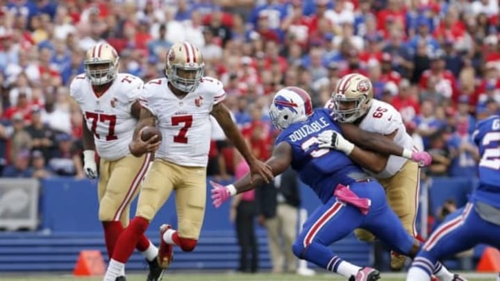 Oct 16, 2016; Orchard Park, NY, USA; Buffalo Bills defensive tackle Leger Douzable (91) tries to make a tackle on San Francisco 49ers quarterback Colin Kaepernick (7) during the second half at New Era Field. Buffalo beat San Francisco 45-16. Mandatory Credit: Timothy T. Ludwig-USA TODAY Sports