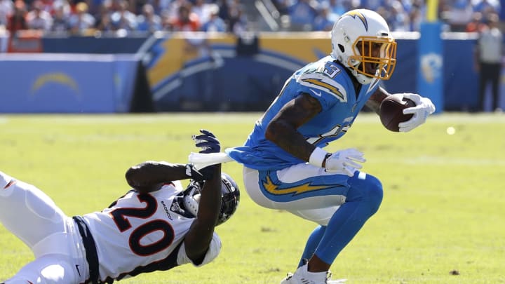CARSON, CALIFORNIA – OCTOBER 06: Keenan Allen #13 of the Los Angeles Chargers breaks a tackle by Duke Dawson #20 of the Denver Broncos during the first half of a game at Dignity Health Sports Park on October 06, 2019 in Carson, California. (Photo by Sean M. Haffey/Getty Images)