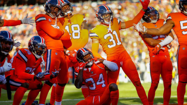 DENVER, CO - NOVEMBER 25: Strong safety Will Parks #34 of the Denver Broncos celebrates with teammates after forcing a fumble and preventing a second quarter touchdown against the Pittsburgh Steelers at Broncos Stadium at Mile High on November 25, 2018 in Denver, Colorado. (Photo by Justin Edmonds/Getty Images)
