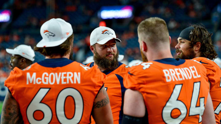DENVER, CO – AUGUST 29: Austin Schlottmann #71 of the Denver Broncos talks to other offensive linemen Connor McGovern #60 and Jake Brendel #64 during a preseason National Football League game against the Arizona Cardinals at Broncos Stadium at Mile High on August 29, 2019 in Denver, Colorado. (Photo by Dustin Bradford/Getty Images)