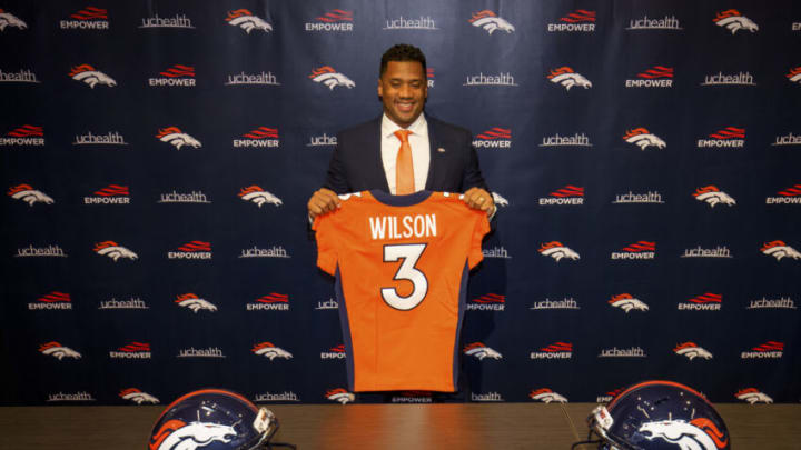 ENGLEWOOD, CO - MARCH 16: Quarterback Russell Wilson #3 of the Denver Broncos poses with his jersey after speaking to the media at UCHealth Training Center on March 16, 2022 in Englewood, Colorado. (Photo by Justin Edmonds/Getty Images)