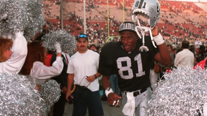 9 JAN 1994: TIM BROWN OF THE LOS ANGELES RAIDERS WITH HELMET ALOFT LEAVES THE FIELD AFTER THE RAIDERS DEFEATED THE DENVER BRONCOS 42-24. Mandatory Credit: Al Bello/ALLSPORT