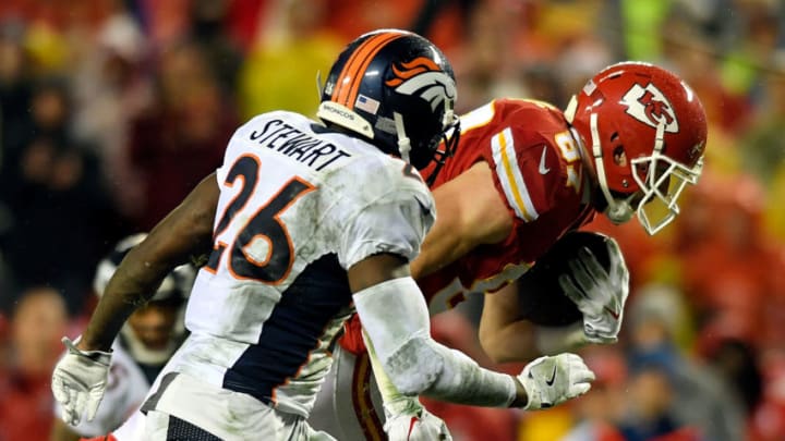KANSAS CITY, MO - DECEMBER 25: Tight end Travis Kelce #87 of the Kansas City Chiefs carries the ball after catching a pass as free safety Darian Stewart #26 and free safety Justin Simmons #31 of the Denver Broncos defend during the game against the Denver Broncos at Arrowhead Stadium on December 25, 2016 in Kansas City, Missouri. (Photo by Reed Hoffmann/Getty Images)