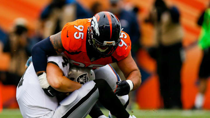 DENVER, CO - OCTOBER 1: Defensive end Derek Wolfe #95 of the Denver Broncos sacks quarterback Derek Carr #4 of the Oakland Raiders at Sports Authority Field at Mile High on October 1, 2017 in Denver, Colorado. (Photo by Justin Edmonds/Getty Images)