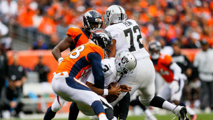 DENVER, CO - OCTOBER 1: Quarterback EJ Manuel #3 of the Oakland Raiders is hit by outside linebacker Von Miller #58 of the Denver Broncos during a game at Sports Authority Field at Mile High on October 1, 2017 in Denver, Colorado. (Photo by Justin Edmonds/Getty Images)