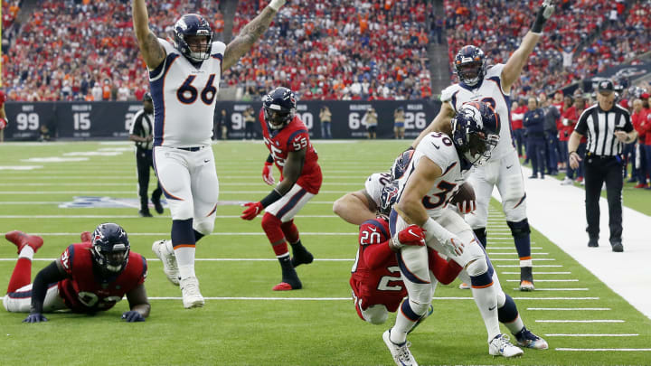 HOUSTON, TEXAS – DECEMBER 08: Phillip Lindsay #30 of the Denver Broncos scores a touchdown as Justin Reid #20 of the Houston Texans defends in the second quarter at NRG Stadium on December 08, 2019 in Houston, Texas.Dalton Risner #66 of the Denver Broncos celebrates the touchdown. (Photo by Bob Levey/Getty Images)