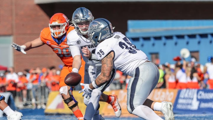BOISE, ID – OCTOBER 2: Quarterback Carson Strong #12 pitches the ball to running back Toa Taua #35 of the Nevada Wolf Pack during second half action against the Boise State Broncos on October 2, 2021 at Albertsons Stadium in Boise, Idaho. Nevada won the game 41-31. (Photo by Loren Orr/Getty Images)