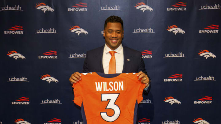 ENGLEWOOD, CO - MARCH 16: Quarterback Russell Wilson #3 of the Denver Broncos poses with his jersey after speaking to the media at UCHealth Training Center on March 16, 2022 in Englewood, Colorado. (Photo by Justin Edmonds/Getty Images)