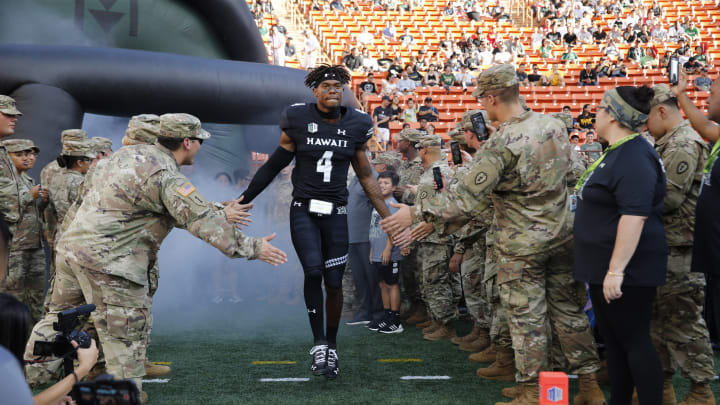 Sep 1, 2018; Honolulu, HI, USA; Hawaii Warriors defensive back Rojesterman Farris II (4) runs through a group of Army soldiers before the start of a game against the Navy Midshipmen at Aloha Stadium. Mandatory Credit: Marco Garcia-USA TODAY Sports