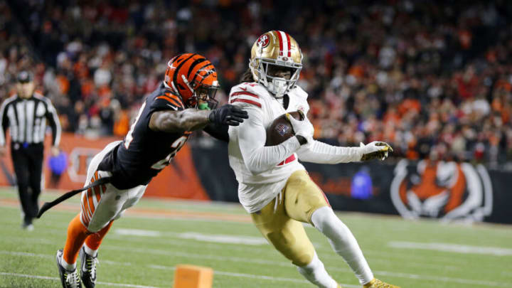 Dec 12, 2021; Cincinnati, Ohio, USA; San Francisco 49ers wide receiver Brandon Aiyuk (11) scores the winning touchdown in overtime as Cincinnati Bengals safety Vonn Bell (24) attempts the tackle at Paul Brown Stadium. Mandatory Credit: Joseph Maiorana-USA TODAY Sports