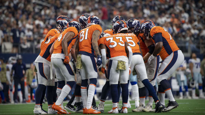 Nov 7, 2021; Arlington, Texas, USA; The Denver Broncos offense sets the play during the game between the Dallas Cowboys and the Denver Broncos at AT&T Stadium. Mandatory Credit: Jerome Miron-USA TODAY Sports