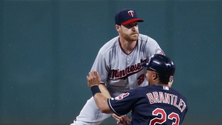 CLEVELAND, OH - AUGUST 07: Logan Forsythe #24 of the Minnesota Twins forces out Michael Brantley #23 of the Cleveland Indians at second base during the first inning at Progressive Field on August 7, 2018 in Cleveland, Ohio. (Photo by Ron Schwane/Getty Images)