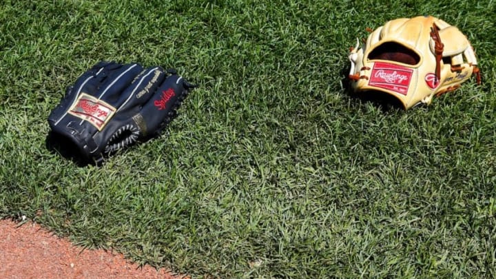 BOSTON, MA - June 4: Two Rawlings baseball gloves are seen on the field before the game between the Boston Red Sox and the Minnesota Twins at Fenway Park on June 4, 2015 in Boston, Massachusetts. (Photo by Winslow Townson/Getty Images)
