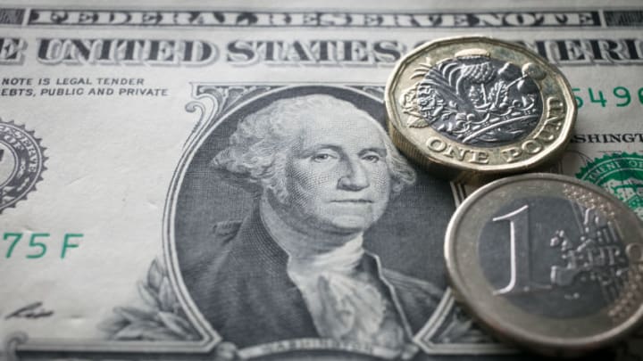 BATH, ENGLAND - OCTOBER 13: In this photo illustration, a £1 coin is seen a US dollar bill and 1 euro coin on October 13, 2017 in Bath, England. Currency experts have warned that as the uncertainty surrounding Brexit continues, the value of the British pound, which has remained depressed against the US dollar and the euro since the UK voted to leave in the EU referendum, is likely to fluctuate. (Photo Illustration by Matt Cardy/Getty Images)