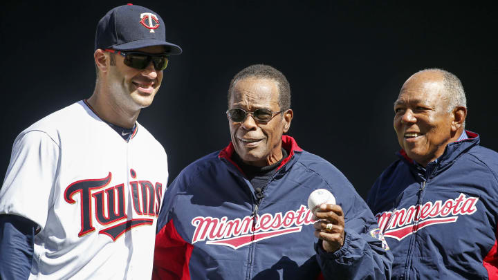 Apr 11, 2016; Minneapolis, MN, USA; Minnesota Twins hall of fame player Rod Carew (center) holds out a ceremonial first pitch brought to him by former teammate Tony Oliva that he threw to first baseman Joe Mauer (7) before the game between the Twins and the Chicago White Sox at Target Field. Mandatory Credit: Bruce Kluckhohn-USA TODAY Sports