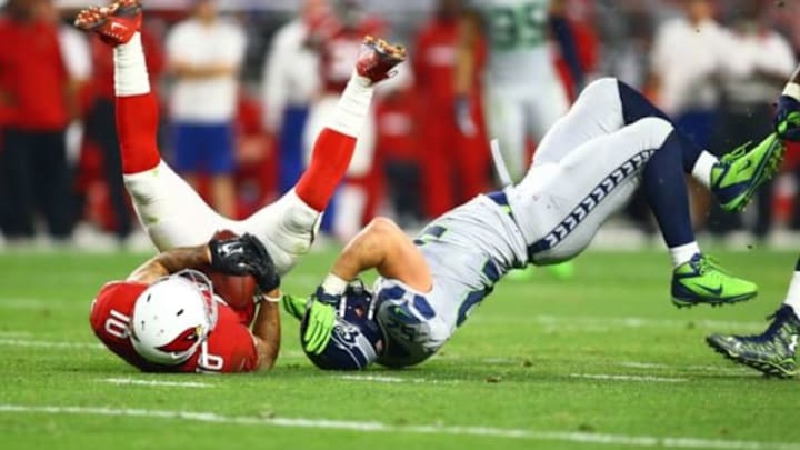 Jan 3, 2016; Glendale, AZ, USA; Arizona Cardinals wide receiver Brittan Golden (10) is tackled by Seattle Seahawks linebacker Brock Coyle (52) in the second half at University of Phoenix Stadium. Mandatory Credit: Mark J. Rebilas-USA TODAY Sports