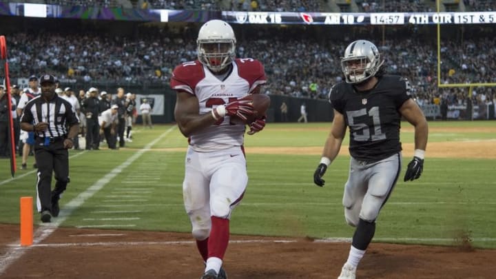 August 30, 2015; Oakland, CA, USA; Arizona Cardinals running back David Johnson (31) catches a touchdown pass against Oakland Raiders inside linebacker Ben Heeney (51) during the fourth quarter in a preseason NFL football game at O.co Coliseum. The Cardinals defeated the Raiders 30-23. Mandatory Credit: Kyle Terada-USA TODAY Sports