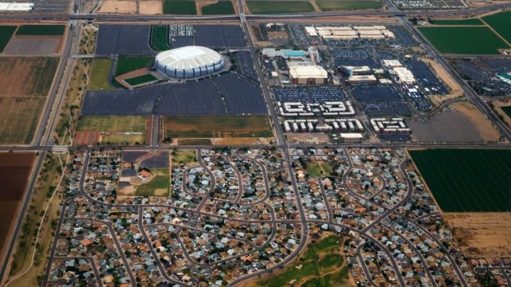 Apr 10, 2016; Glendale, AZ, USA; Aerial view of University of Phoenix Stadium (left), home of the Arizona Cardinals NFL football team. Also visible is the Gila River Arena in the Westgate Entertainment District , home of the Arizona Coyotes NHL hockey team near a residential housing development. Mandatory Credit: Mark J. Rebilas-USA TODAY Sports