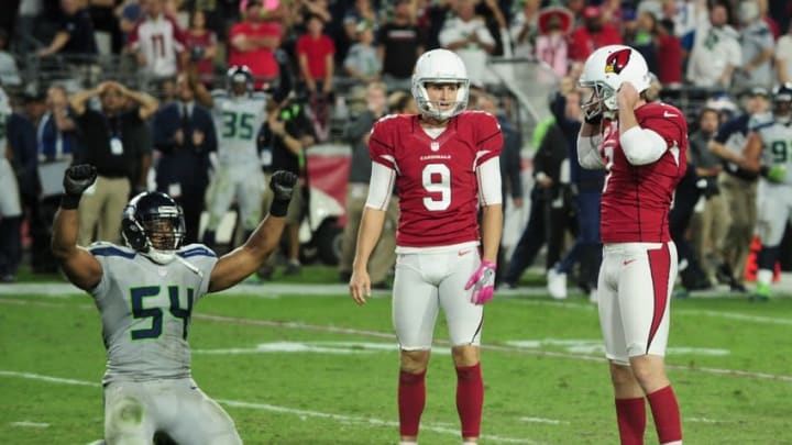 Oct 23, 2016; Glendale, AZ, USA; Arizona Cardinals kicker Chandler Catanzaro (7) reacts after missing a field goal in overtime as punter Ryan Quigley (9) and Seattle Seahawks middle linebacker Bobby Wagner (54) react at University of Phoenix Stadium. Mandatory Credit: Matt Kartozian-USA TODAY Sports