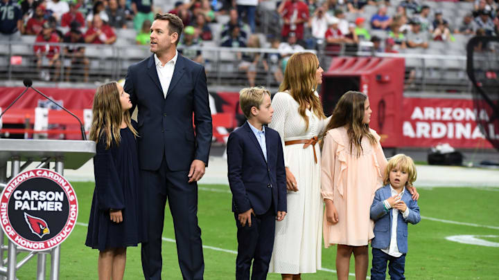 GLENDALE, ARIZONA – SEPTEMBER 29: Former Arizona Cardinals quarterback Carson Palmer and his family stand at mid field while being inducted into the Cardinals Ring of Honor at halftime of a game against the Seattle Seahawks at State Farm Stadium on September 29, 2019 in Glendale, Arizona. (Photo by Norm Hall/Getty Images)