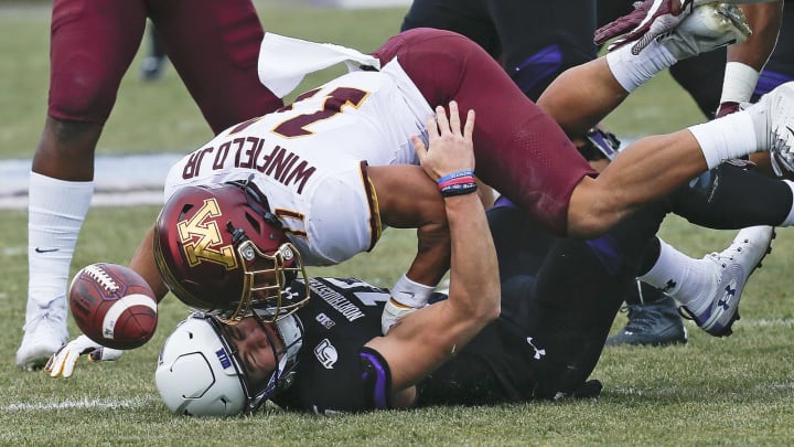 EVANSTON, ILLINOIS – NOVEMBER 23: Hunter Johnson #15 of the Northwestern Wildcats is sacked by Antoine Winfield Jr. #11 of the Minnesota Golden Gophers during the first half at Ryan Field on November 23, 2019 in Evanston, Illinois. (Photo by Nuccio DiNuzzo/Getty Images)