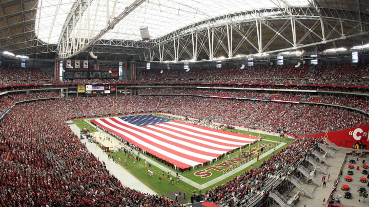 GLENDALE, AZ – SEPTEMBER 11: The American flag is unveiled on the field as Jordin Sparks performs the National Anthem before the NFL season opening game between the Carolina Panthers and the Arizona Cardinals at the University of Phoenix Stadium on September 11, 2011 in Glendale, Arizona. The Cardinals defeated the Panthers 28-21. (Photo by Christian Petersen/Getty Images)