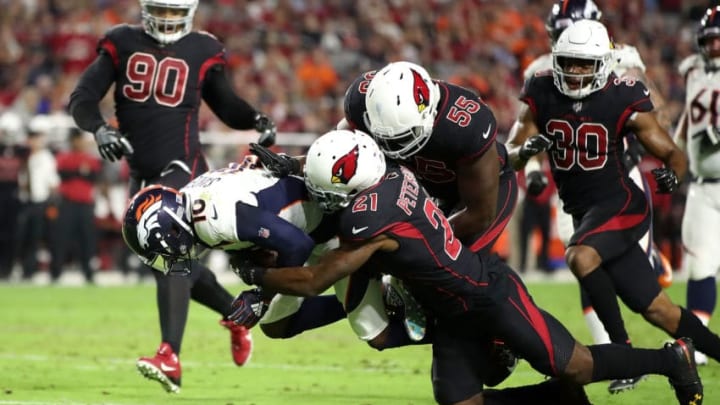 GLENDALE, AZ - OCTOBER 18: Cornerback Patrick Peterson #21 and defensive end Chandler Jones #55 of the Arizona Cardinals tackle wide receiver Emmanuel Sanders #10 of the Denver Broncos during the second quarter at State Farm Stadium on October 18, 2018 in Glendale, Arizona. (Photo by Christian Petersen/Getty Images)