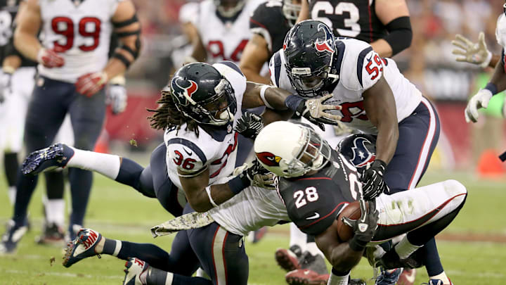 GLENDALE, AZ – NOVEMBER 10: Running back Rashard Mendenhall #28 of the Arizona Cardinals is tackled bylinebacker Whitney Mercilus #59 and safety D.J. Swearinger #36 of the Houston Texans at University of Phoenix Stadium on November 10, 2013 in Glendale, Arizona. The Cardinals won 27-24. (Photo by Stephen Dunn/Getty Images)