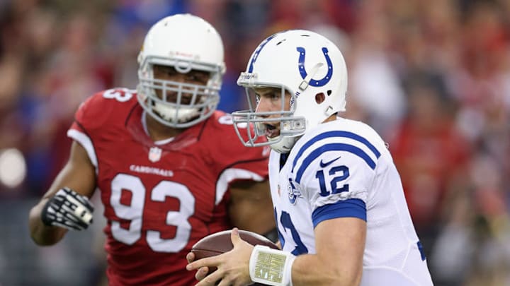GLENDALE, AZ - NOVEMBER 24: Quarterback Andrew LuckGLENDALE, AZ - NOVEMBER 24: Quarterback Andrew Luck #12 of the Indianapolis Colts runs with the football past defensive end Calais Campbell #93 of the Arizona Cardinals during the NFL game at the University of Phoenix Stadium on November 24, 2013 in Glendale, Arizona. (Photo by Christian Petersen/Getty Images)