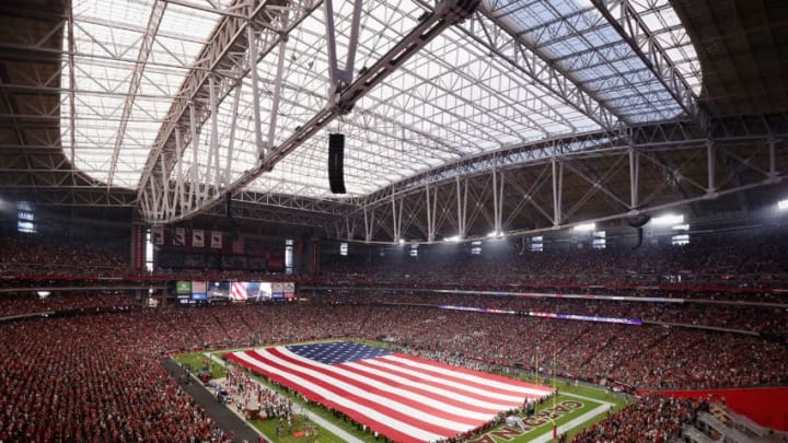 GLENDALE, AZ - SEPTEMBER 11: The american flag is draped across the field for the national anthem to the NFL game between the Arizona Cardinals and the New England Patriots at the University of Phoenix Stadium on September 11, 2016 in Glendale, Arizona. (Photo by Christian Petersen/Getty Images)