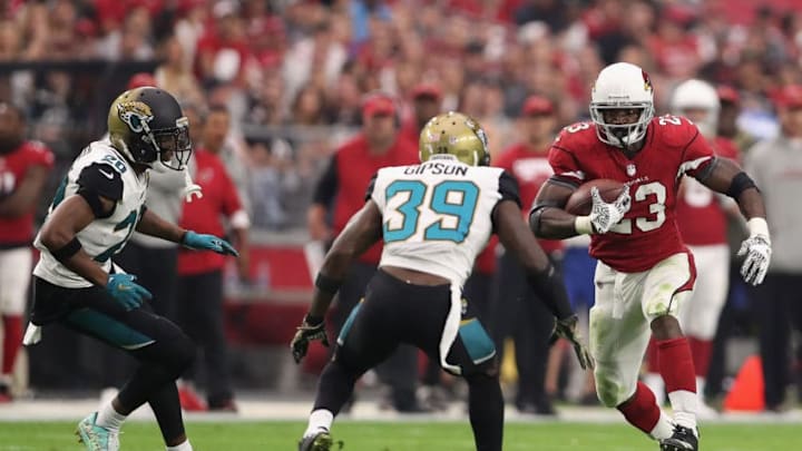 GLENDALE, AZ - NOVEMBER 26: Running back Adrian Peterson #23 of the Arizona Cardinals rushes the football against cornerback Jalen Ramsey #20 and free safety Tashaun Gipson #39 of the Jacksonville Jaguars during the first half of the NFL game at the University of Phoenix Stadium on November 26, 2017 in Glendale, Arizona. The Cardinals defeated the Jaguars 27-24. (Photo by Christian Petersen/Getty Images)