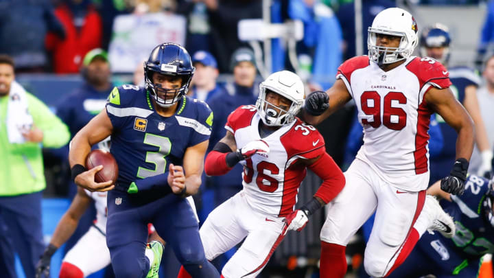 SEATTLE, WA – DECEMBER 31: Quarterback Russell Wilson #3 of the Seattle Seahawks rushes for 31 yards in the fourth quarter against the Arizona Cardinals, including Budda Baker #36 and Kareem Martin #96 at CenturyLink Field on December 31, 2017 in Seattle, Washington. (Photo by Jonathan Ferrey/Getty Images)