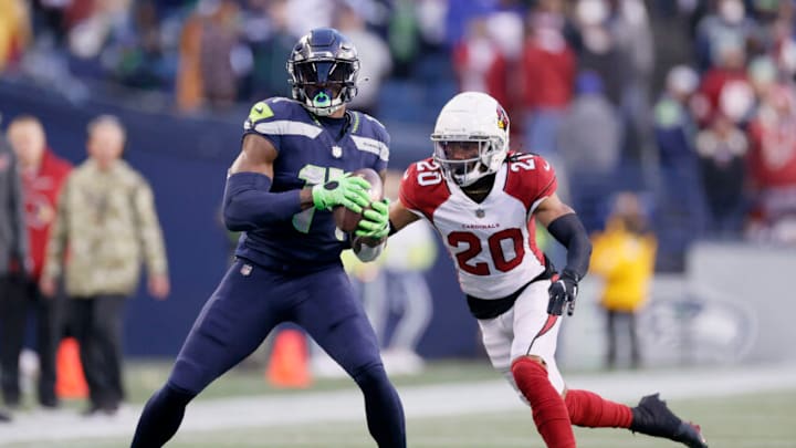 SEATTLE, WASHINGTON - NOVEMBER 21: DK Metcalf #14 of the Seattle Seahawks makes a catch in front of Marco Wilson #20 of the Arizona Cardinals during the second half at Lumen Field on November 21, 2021 in Seattle, Washington. (Photo by Steph Chambers/Getty Images)