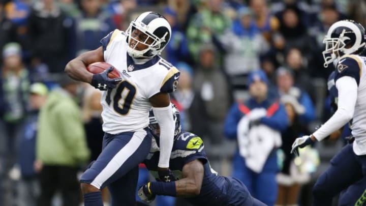 SEATTLE, WA - DECEMBER 17: Pharoh Cooper #10 of the Los Angeles Rams tries to break a tackle by cornerback Neiko Thorpe #23 of the Seattle Seahawks as he takes a return to the one-yard line during the first quarter of the game at CenturyLink Field on December 17, 2017 in Seattle, Washington. (Photo by Otto Greule Jr /Getty Images)