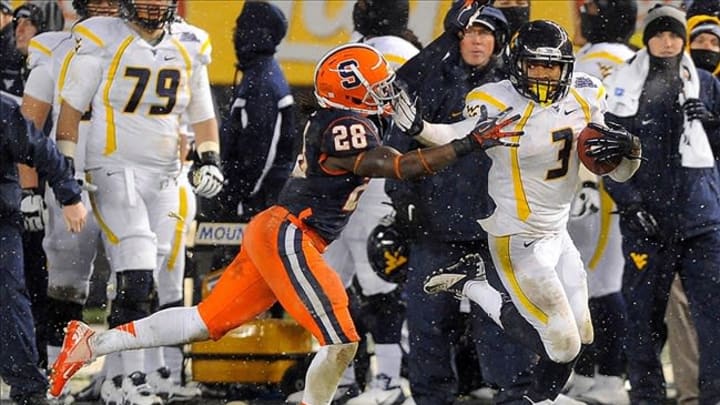 Dec 29, 2012; Bronx, NY, USA; West Virginia Mountaineers wide receiver Stedman Bailey (3) runs with the ball while avoiding the tackle attempt of Syracuse Orange safety Jeremi Wilkes (28) during the third quarter at the 2012 New Era Pinstripe Bowl at Yankee Stadium. Mandatory Credit: Rich Barnes-USA TODAY Sports