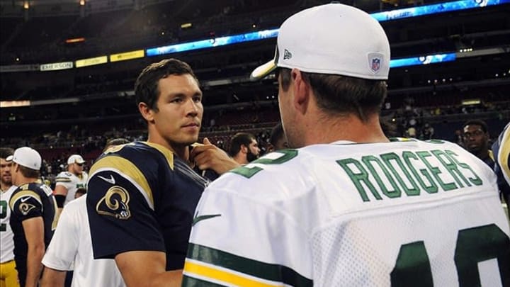 Aug 17, 2013; St. Louis, MO, USA; St. Louis Rams quarterback Sam Bradford (8) talks with Green Bay Packers quarterback Aaron Rodgers (12) after a game at the Edward Jones Dome. Mandatory Credit: Jeff Curry-USA TODAY Sports