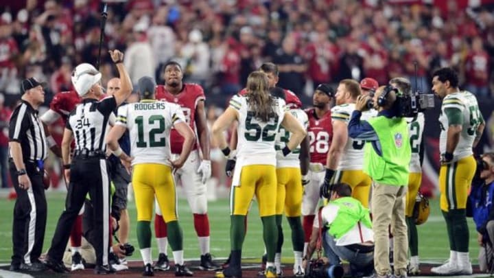 Jan 16, 2016; Glendale, AZ, USA; NFL referee Clete Blakeman (34) flips a coin prior to an NFC Divisional round playoff game between the Arizona Cardinals and the Green Bay Packers at University of Phoenix Stadium. Mandatory Credit: Joe Camporeale-USA TODAY Sports