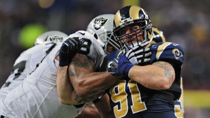 Nov 30, 2014; St. Louis, MO, USA; St. Louis Rams defensive end Chris Long (91) tries to get past Oakland Raiders tackle Khalif Barnes (69) during the second half at the Edward Jones Dome. St. Louis defeated Oakland 52-0. Mandatory Credit: Jeff Curry-USA TODAY Sports